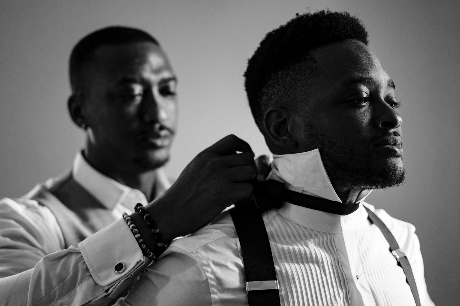 Black and white portrait series showing silhouettes and profiles of people in formal attire.