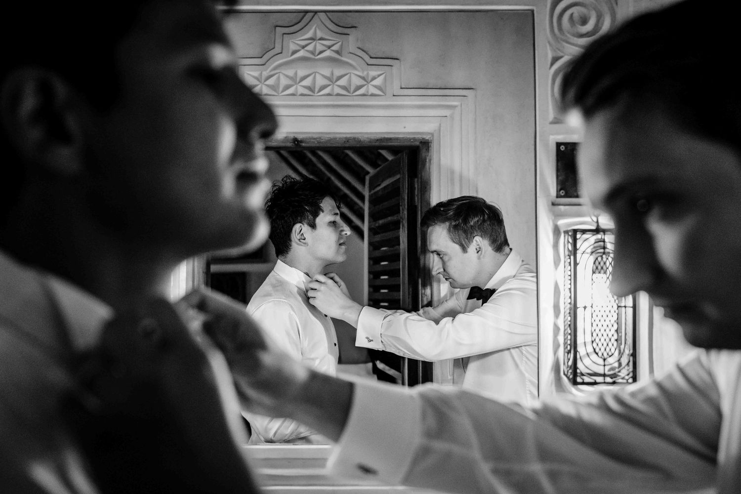 A series of black and white photographs showing intimate moments in what appears to be a domestic setting.