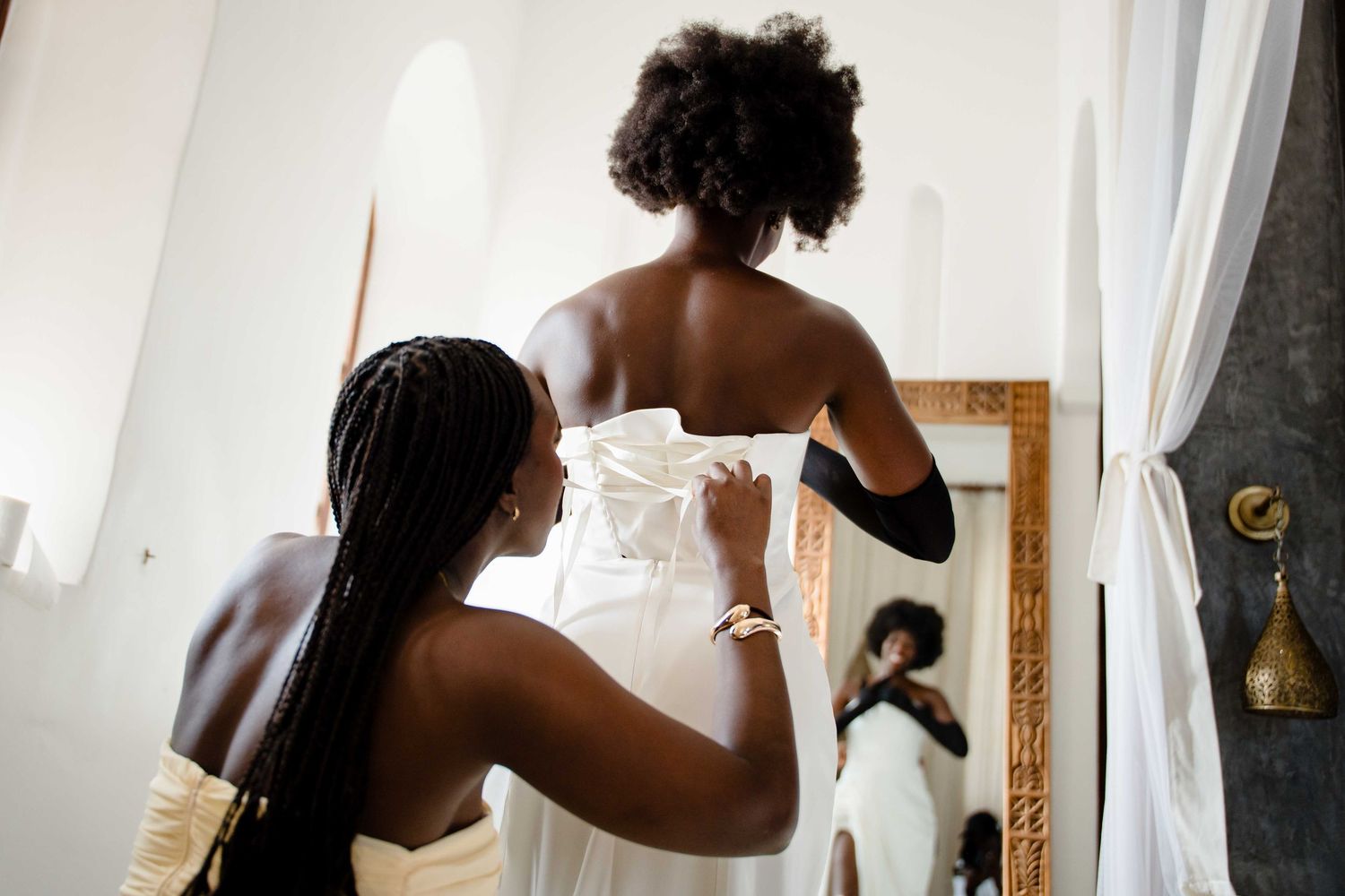 A series of black and white photos showing silhouettes of people getting ready in front of windows.