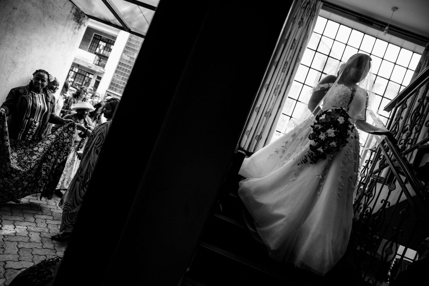 Sunlight streams through large windows in an elegant wedding venue.
