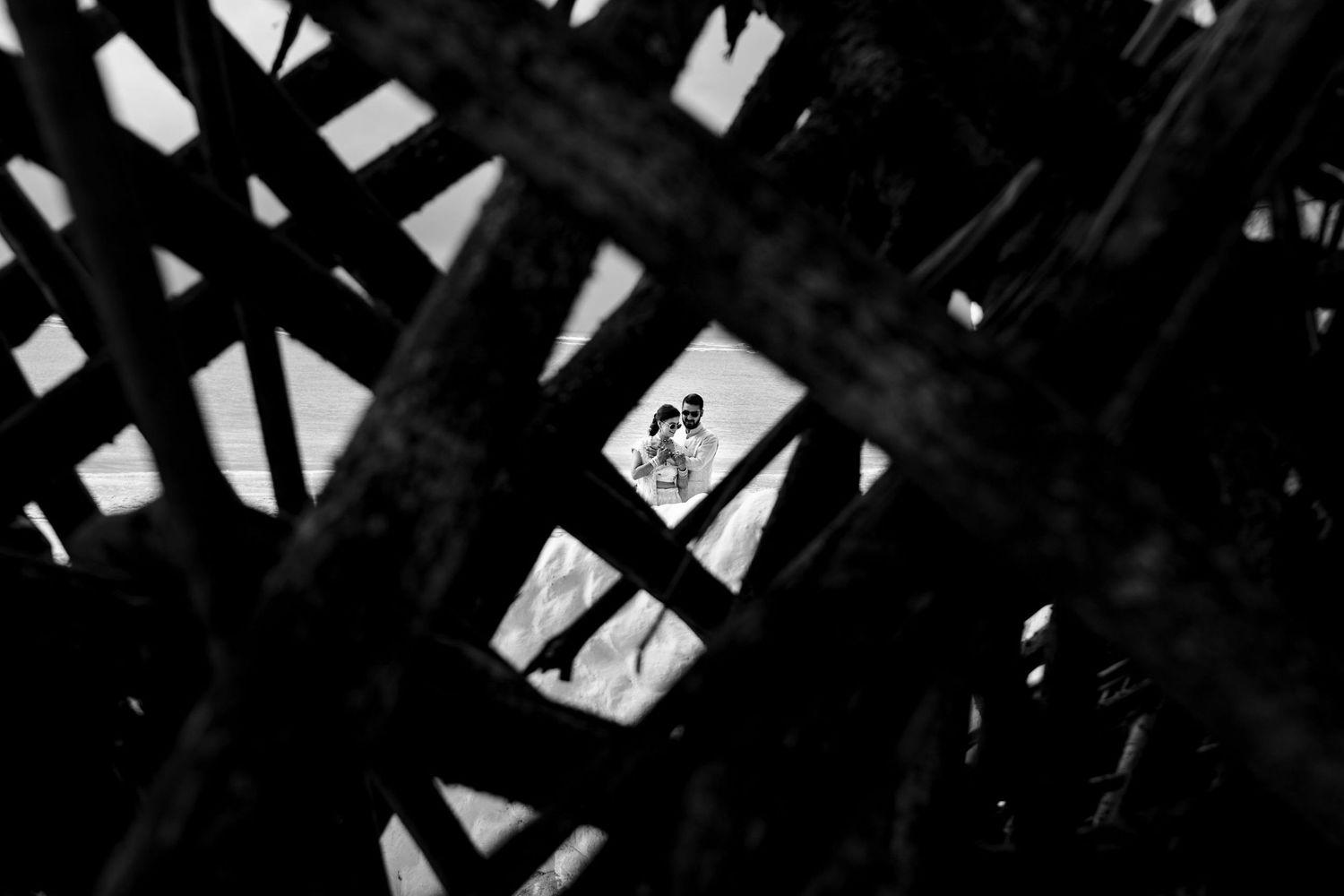 Silhouetted architectural beams create dramatic patterns and shadows.
