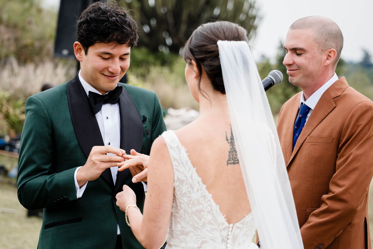 A joyful wedding couple shares a heartfelt moment together during their outdoor ceremony.