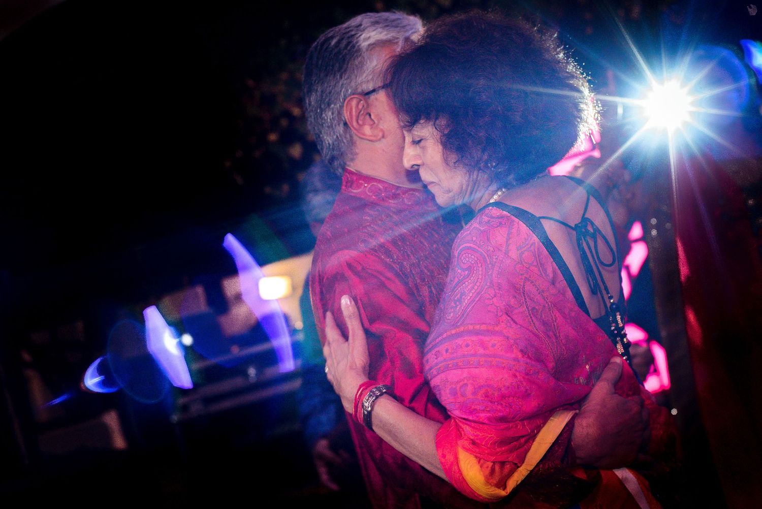 Dance party with pink and blue lighting effects creating a dreamy atmosphere.