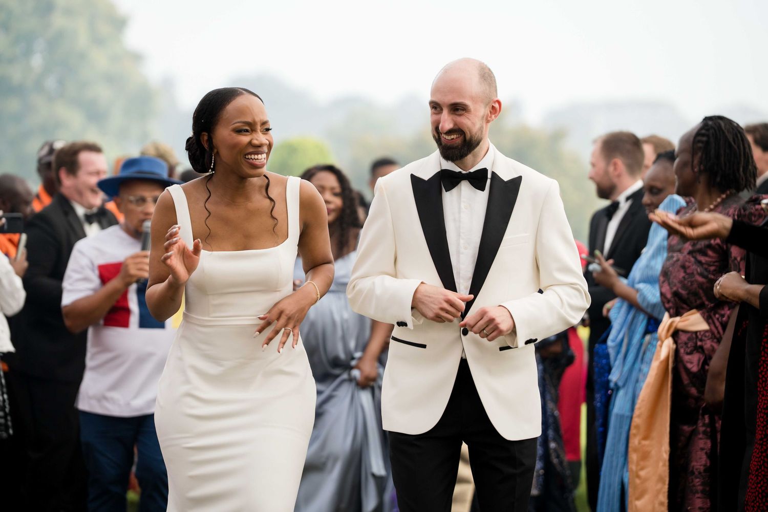 Wedding guests dance and celebrate together on a lively reception dance floor.