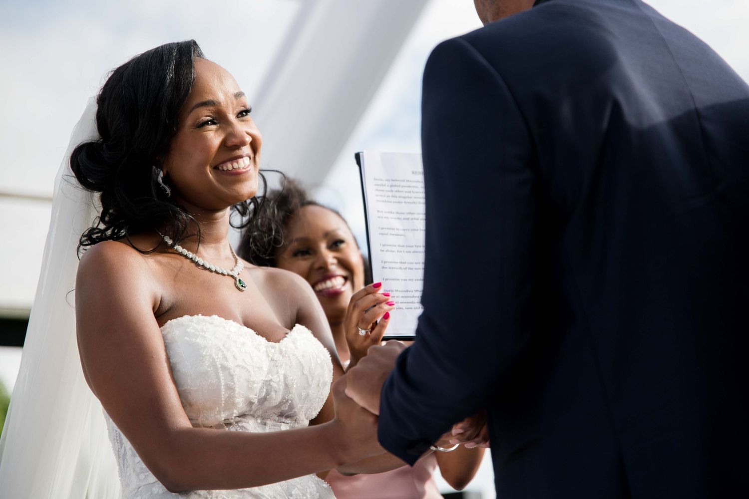 A candid moment of laughter during wedding ceremony vows.
