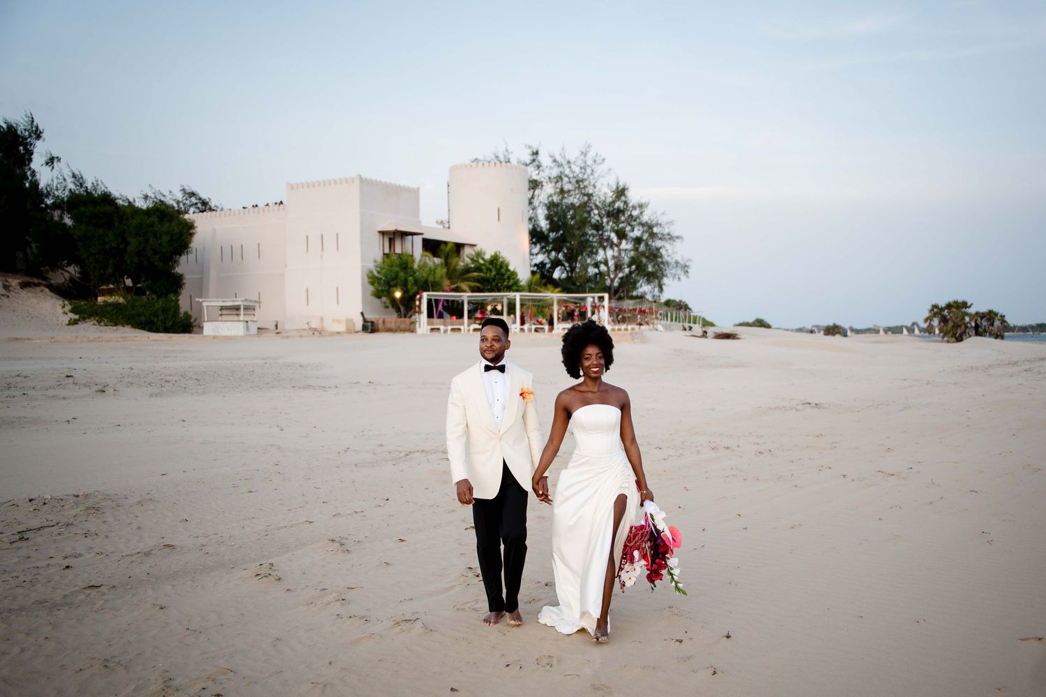 A series of candid beach wedding photos showing people in white attire walking along sandy shores at sunset.