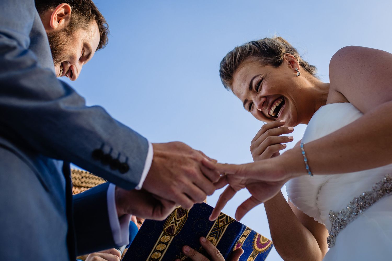 Candid moment during an outdoor celebration with guests seated in a garden setting.