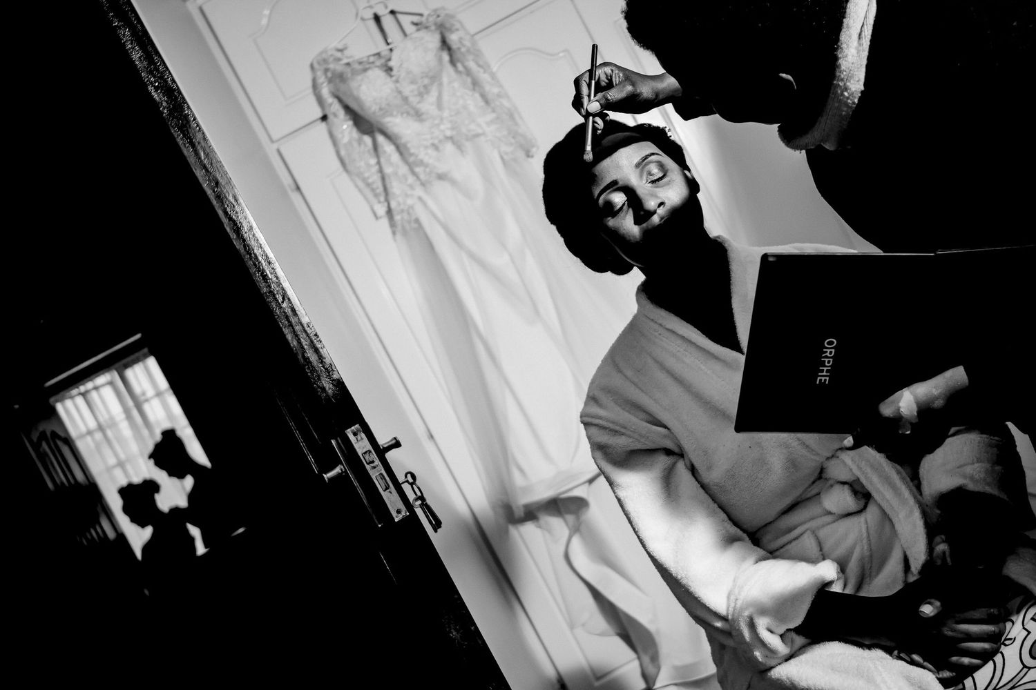 Black and white candid shots capturing wedding day preparations indoors.