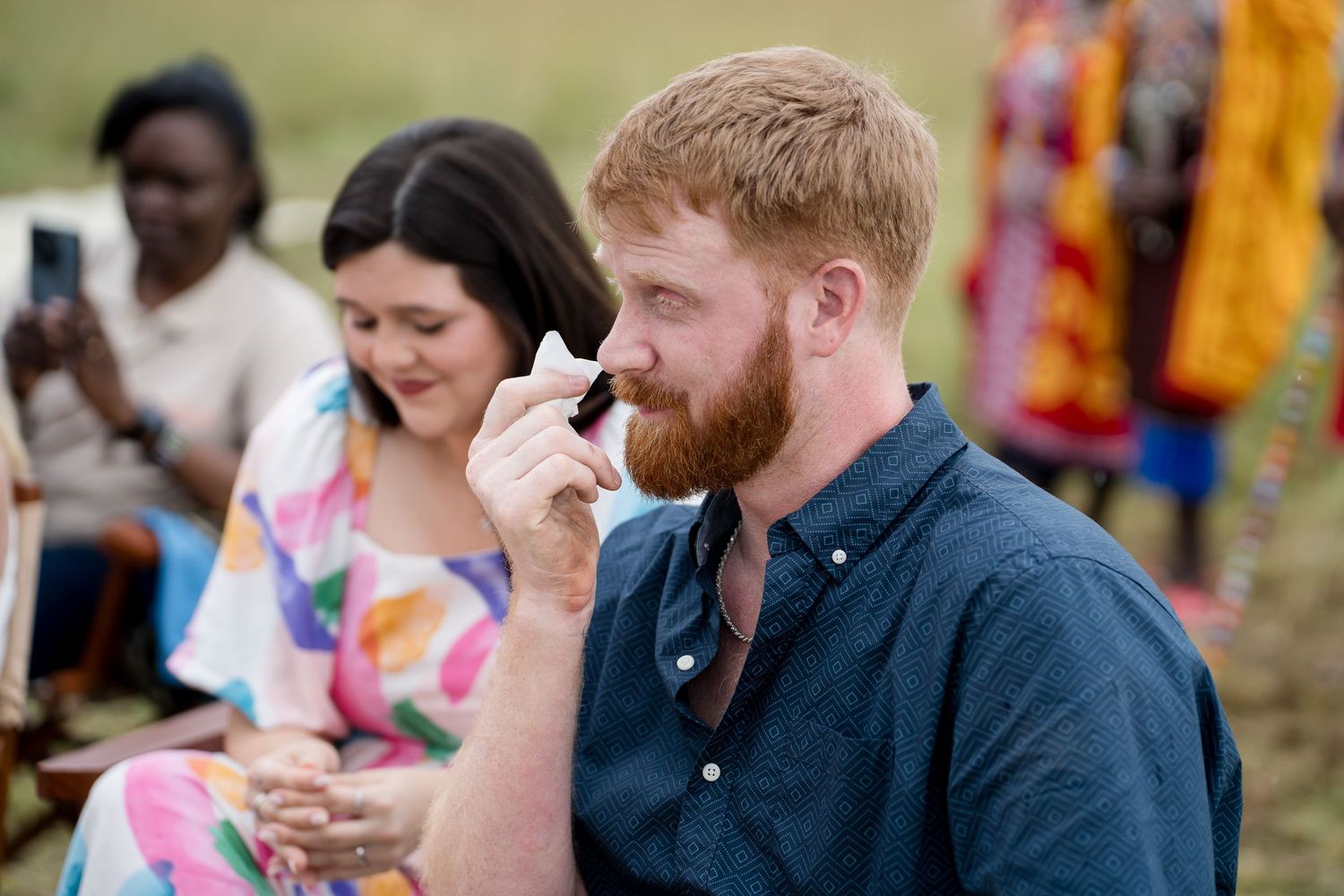 People enjoying refreshments at an outdoor event near colorful decorations.