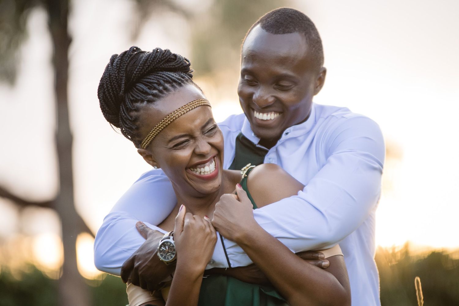 Couples sharing playful and intimate moments during an outdoor sunset photoshoot.