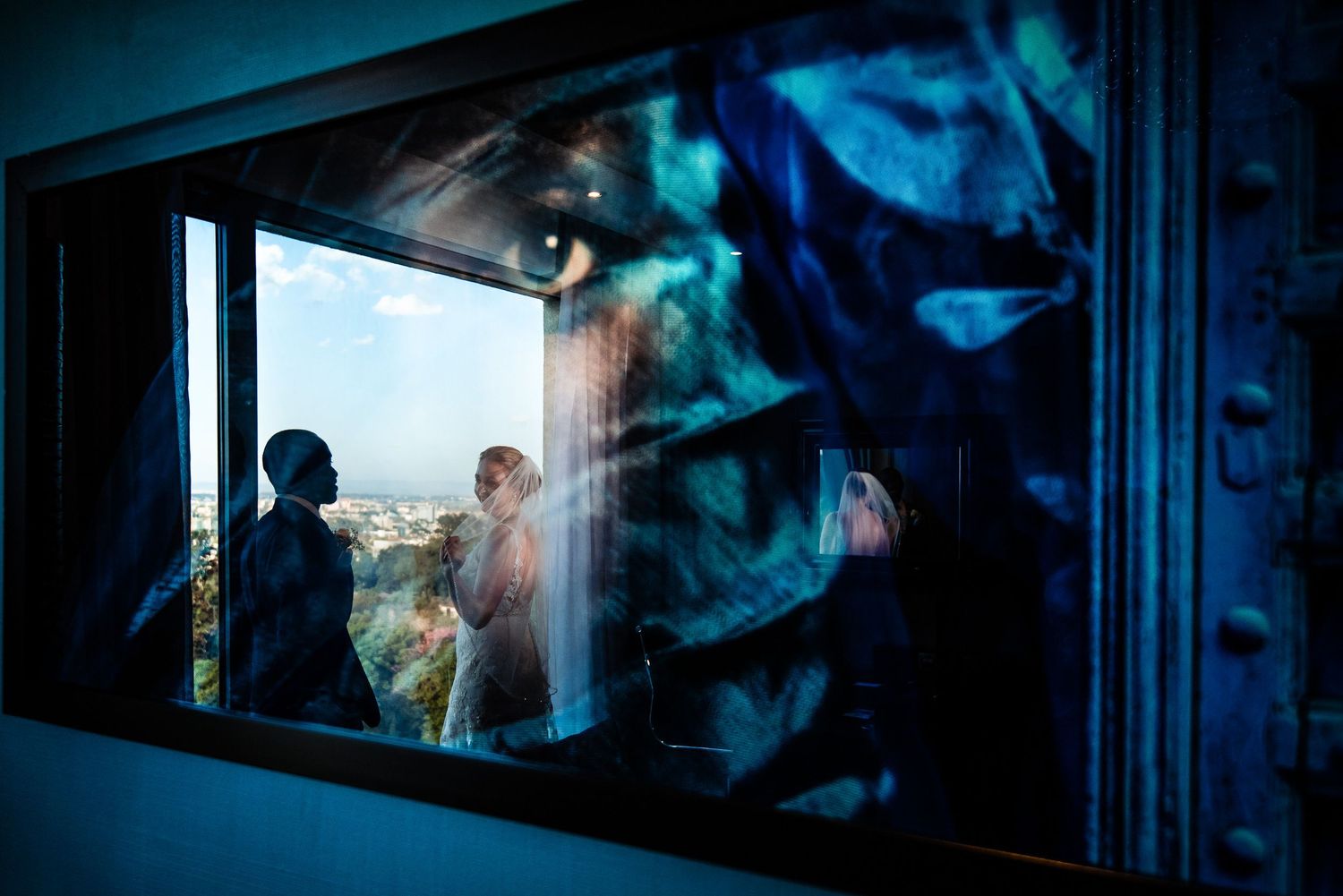 Abstract blue-tinted window reflections creating a moody architectural composition.