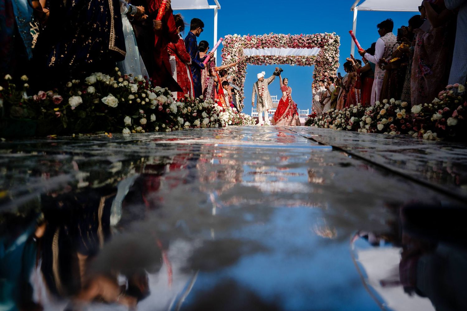 A series of photos showing a traditional Chinese wedding ceremony with red decorations and guests in attendance.