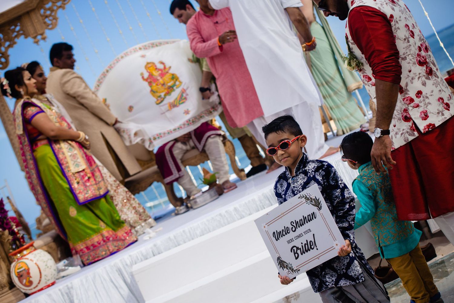 Guests mingling at an outdoor celebration with colorful traditional attire.
