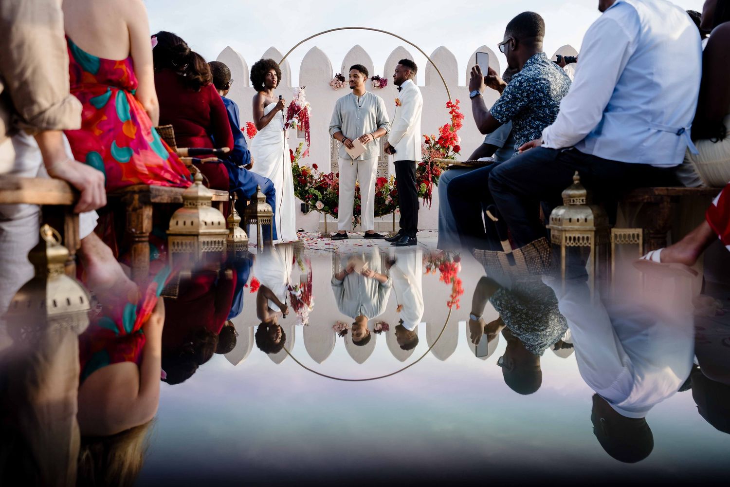 Dancers' feet and legs are reflected in a shiny dance floor during a swing dance performance.