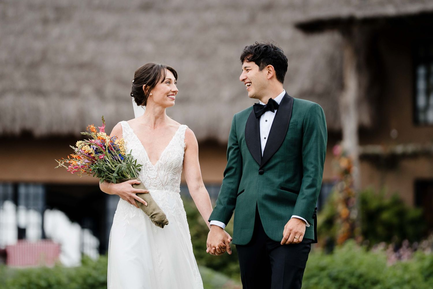 Bride and groom share a joyful moment together outdoors during their wedding celebration.