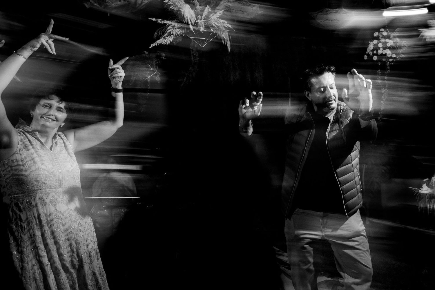 Black and white motion blur captures dancers in dramatic movement.