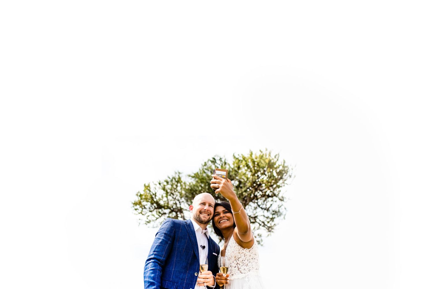 Couple embracing in a garden setting with soft natural lighting.