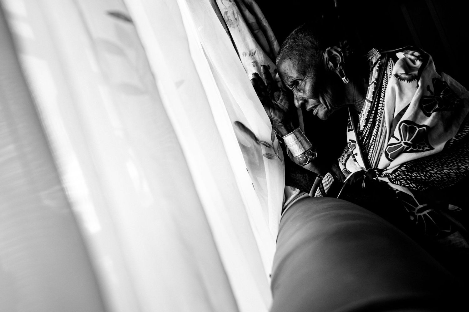 Dramatic black and white wedding photo with light streaming through windows.