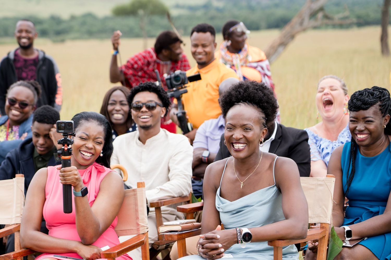 Wedding guests laughing together during outdoor reception.