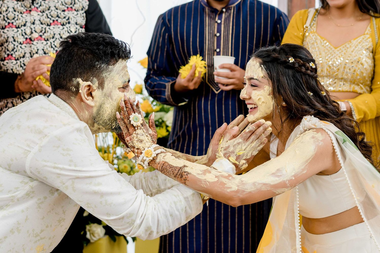 Wedding celebration showing playful moments with colorful decorations and festive attire during a joyous cultural ceremony.