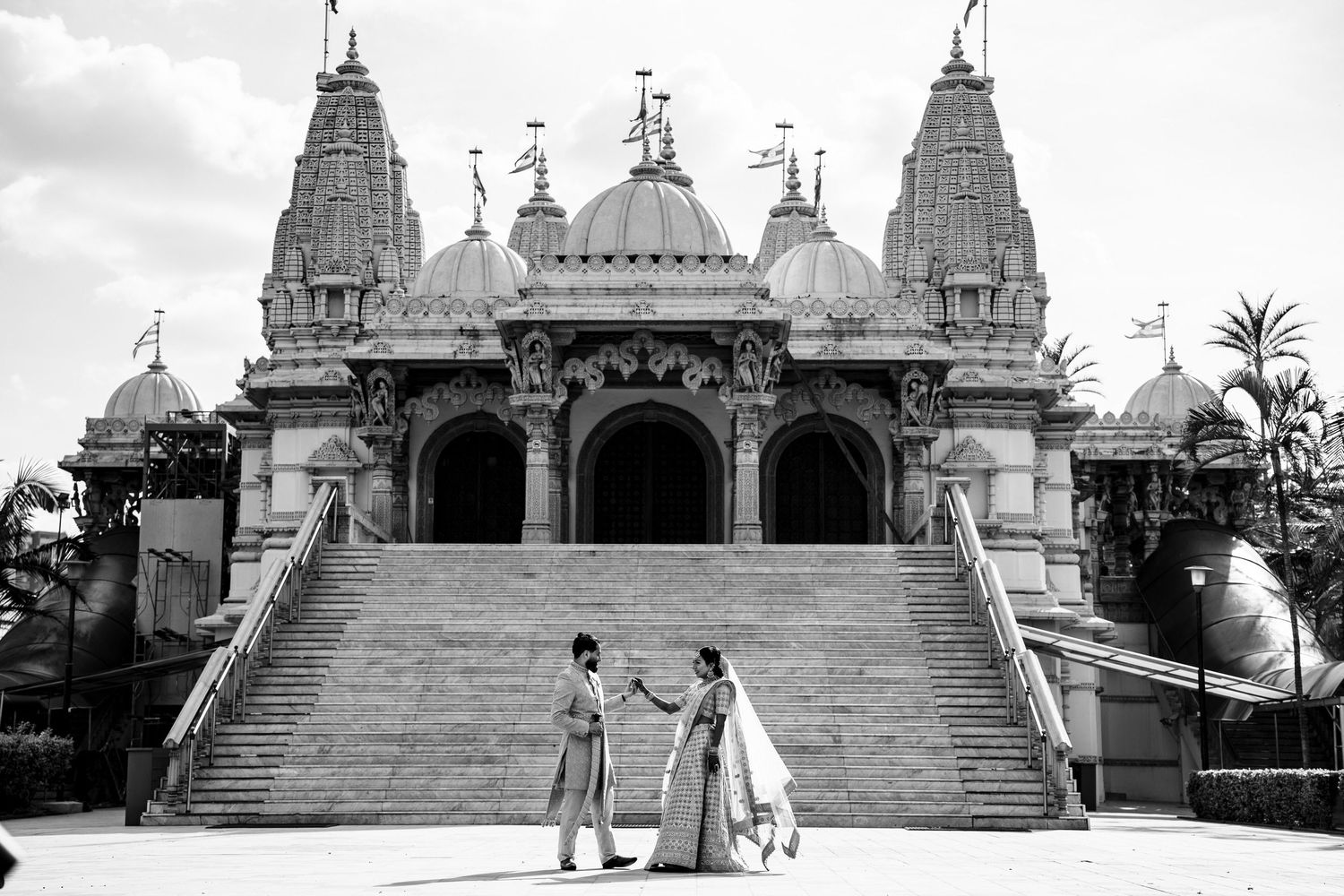 Historic Indian temple architecture with ornate domes and steps in black and white.
