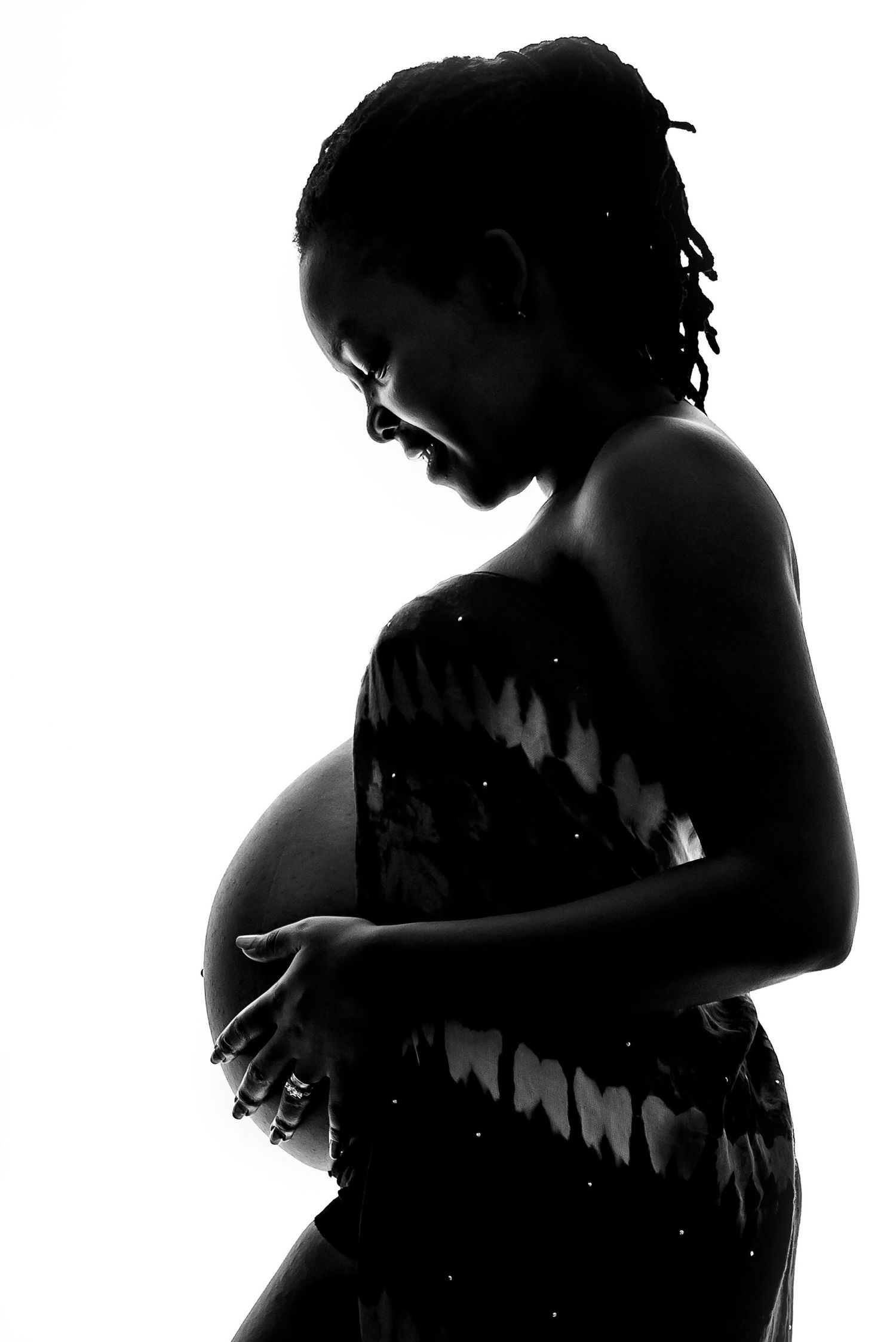 Artistic black and white silhouette series showing intimate maternal moments.