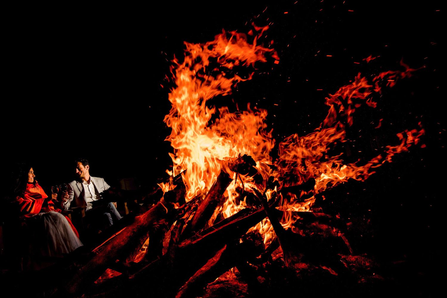 Dramatic flames and fire effects create an intense atmosphere against a dark background.