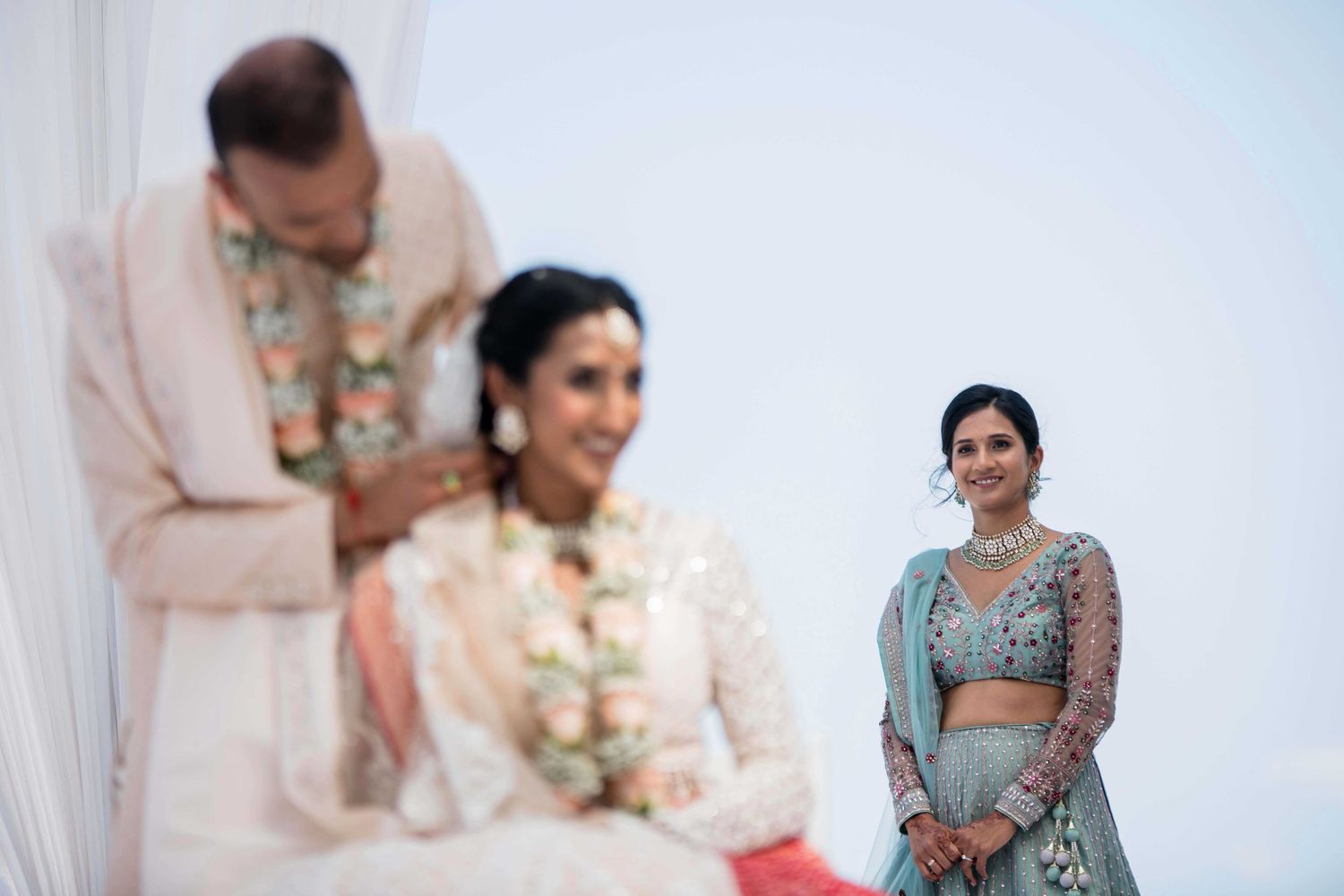 A traditional Indian wedding ceremony with people in elegant attire and decorative outfits.