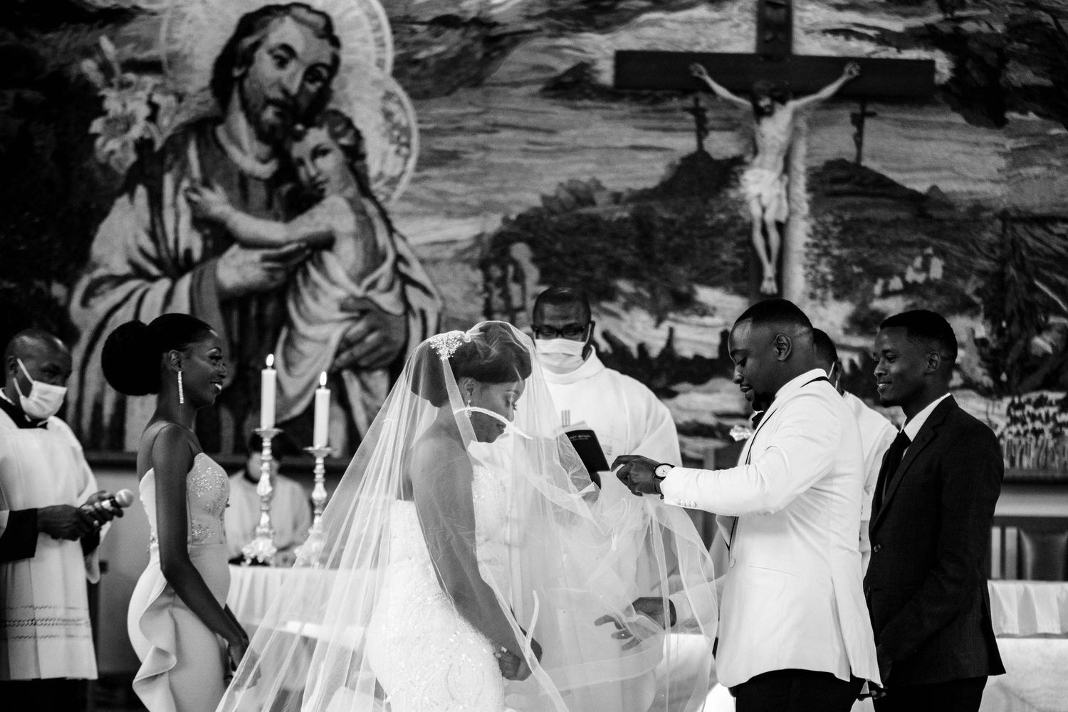 Black and white photo of guests dancing and celebrating at an elegant wedding reception.