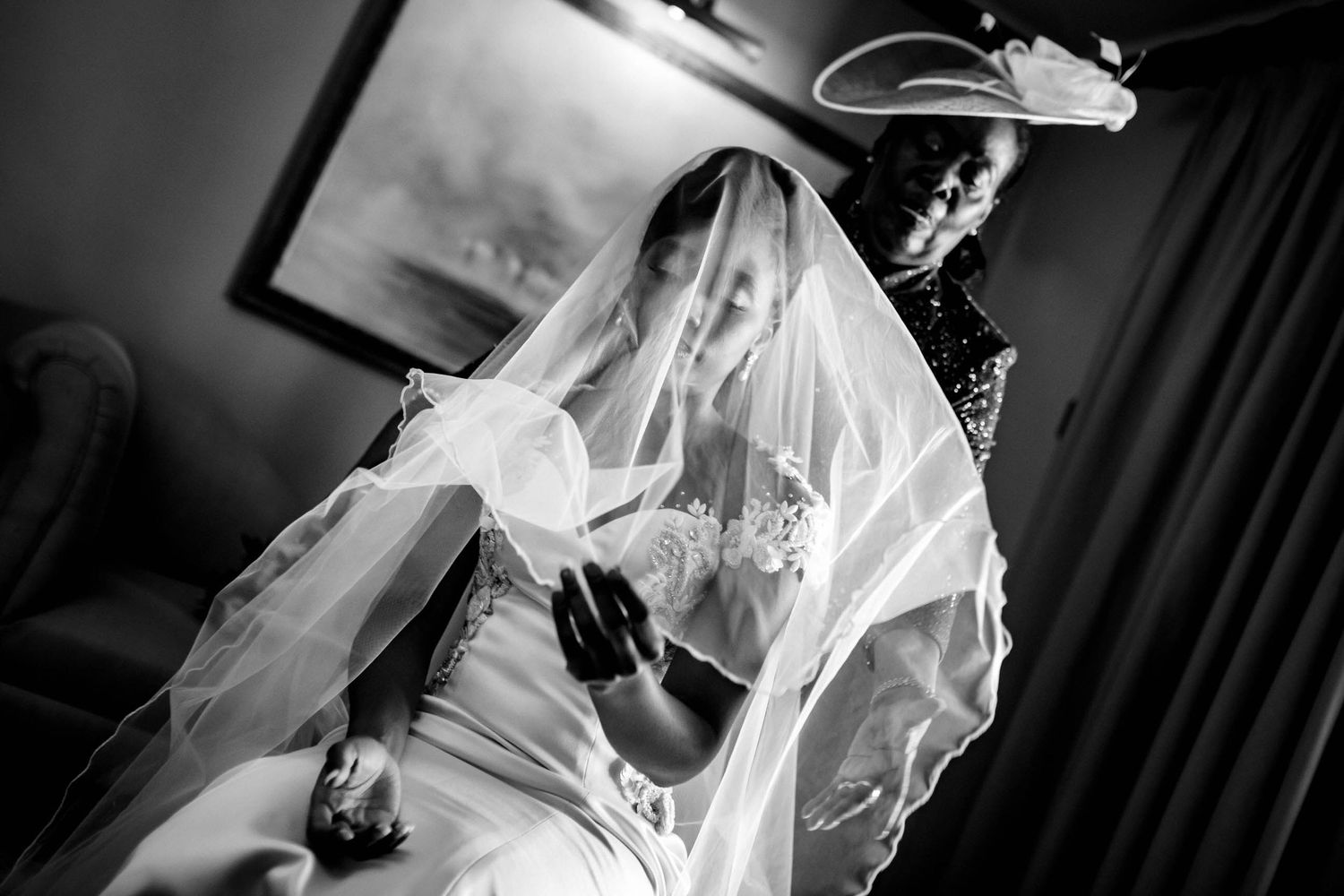 Elegant bridal preparation scene captured in dramatic black and white.