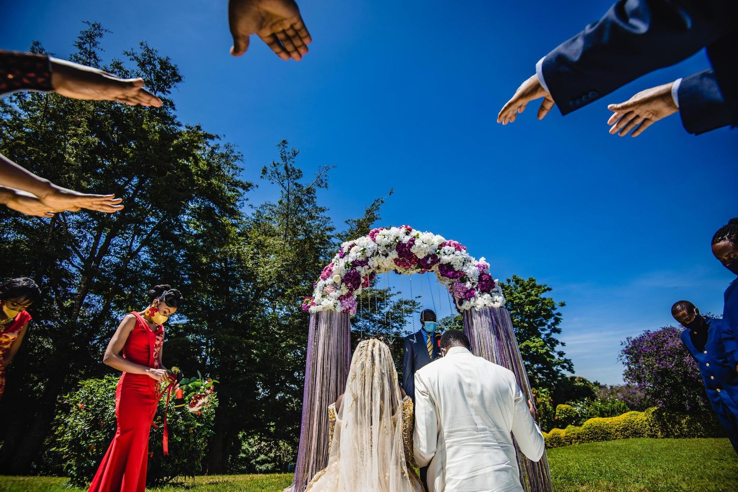 Black and white image of flowing wedding dress and veil caught in the wind.