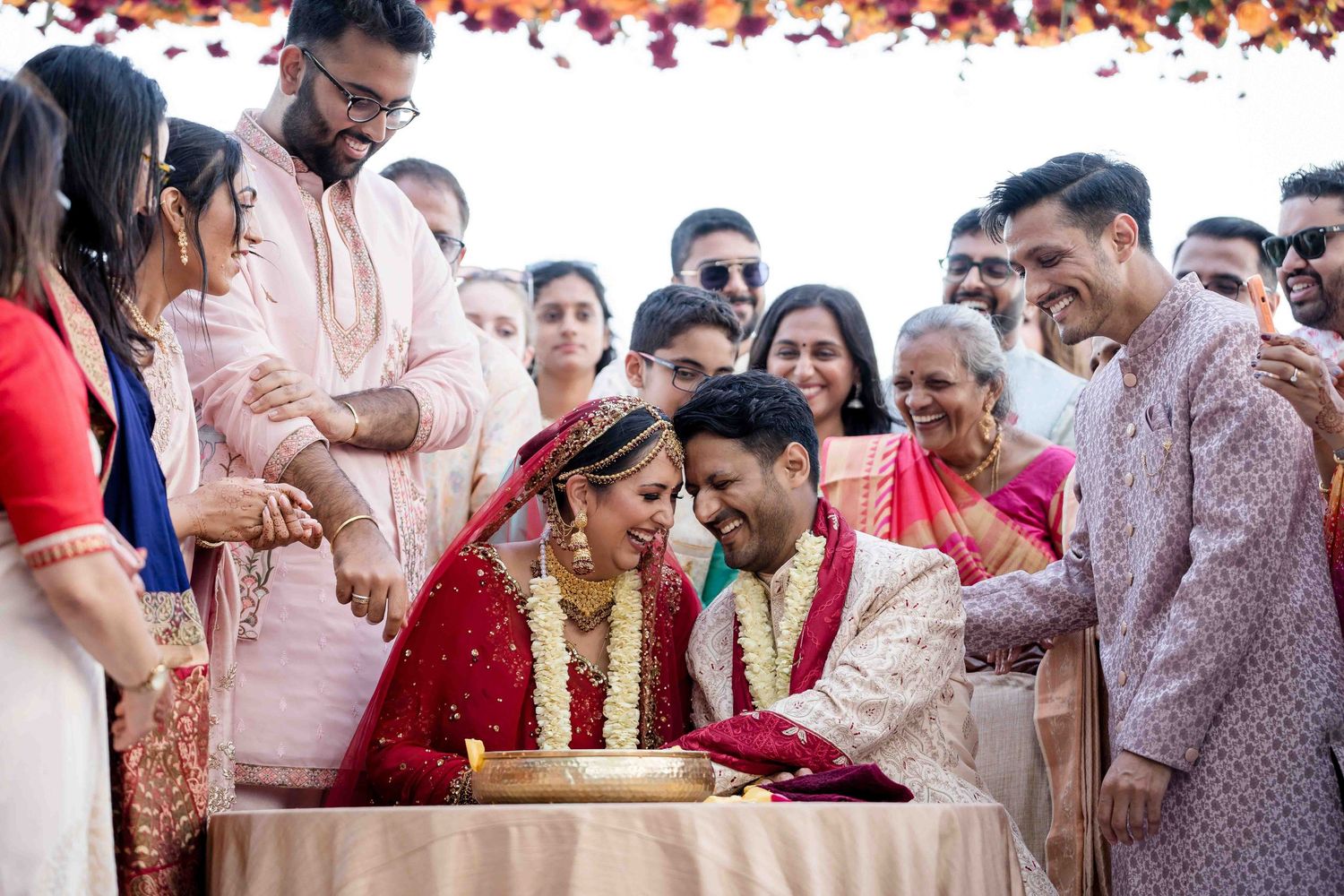 A festive group of wedding guests participate in traditional Indian wedding rituals and celebrations.