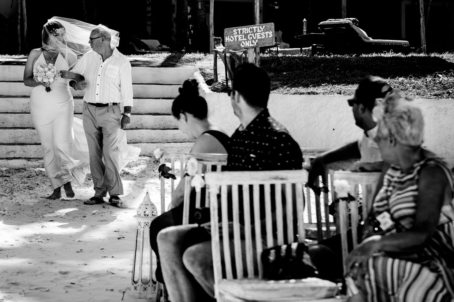 People relaxing on outdoor benches in a casual park or garden setting.