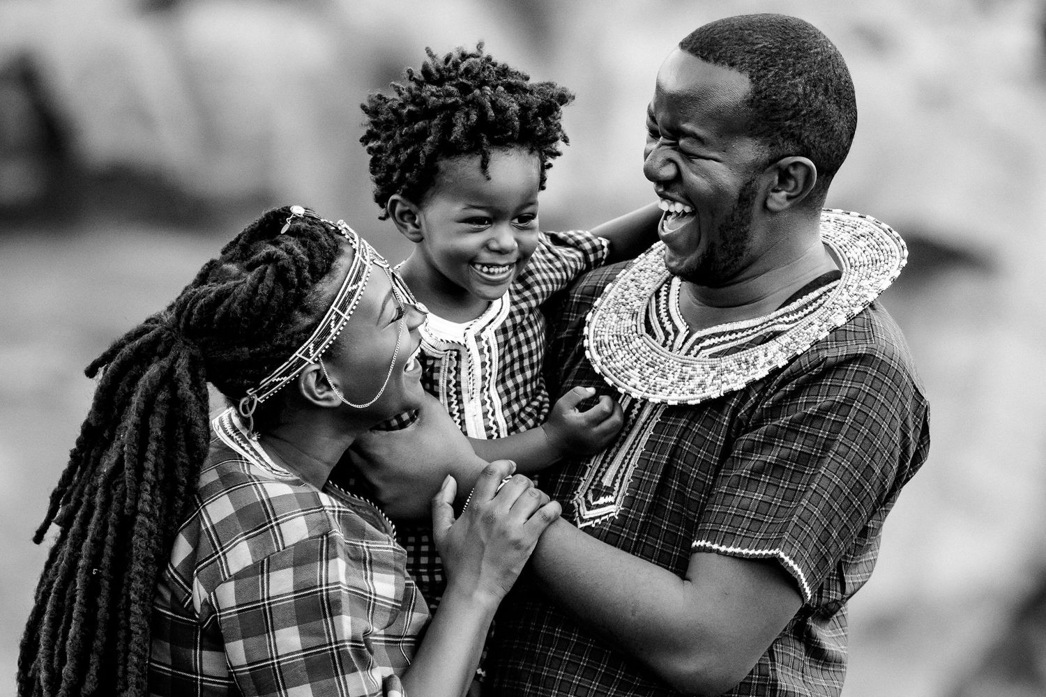 A black and white photo series showing intimate family moments and expressions of joy.