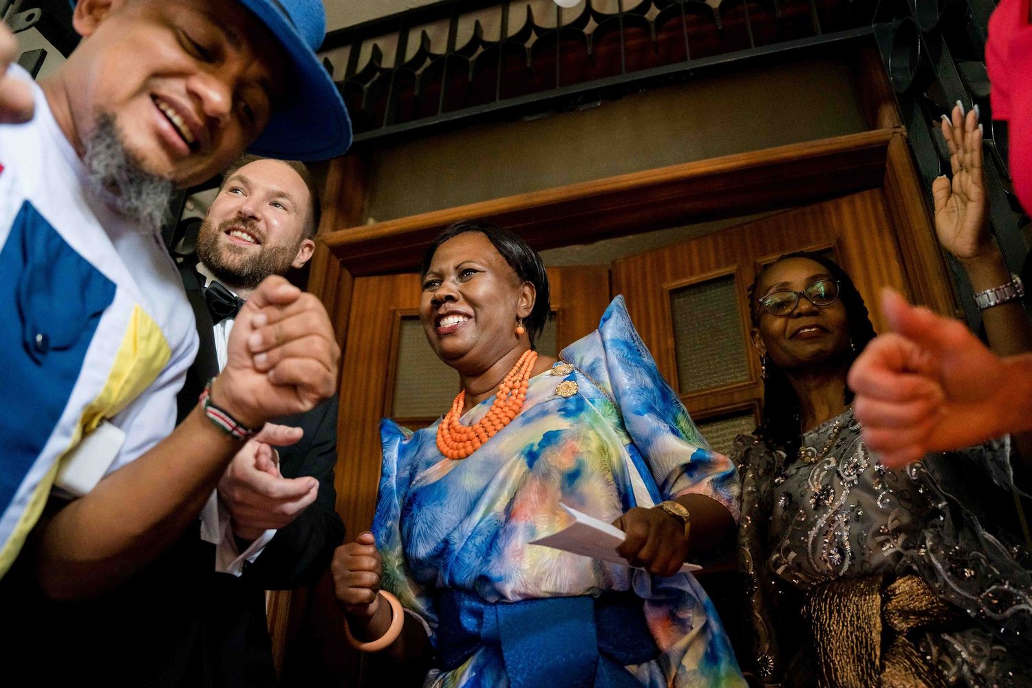 A series of candid photos showing people celebrating and dancing together at what appears to be a party or celebration event.