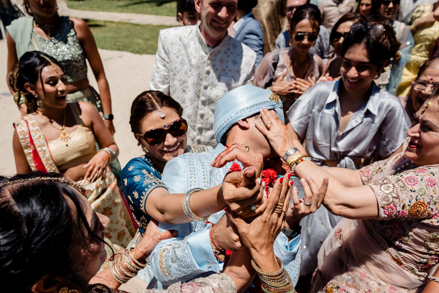 Festive outdoor celebration with guests participating in traditional customs and rituals.
