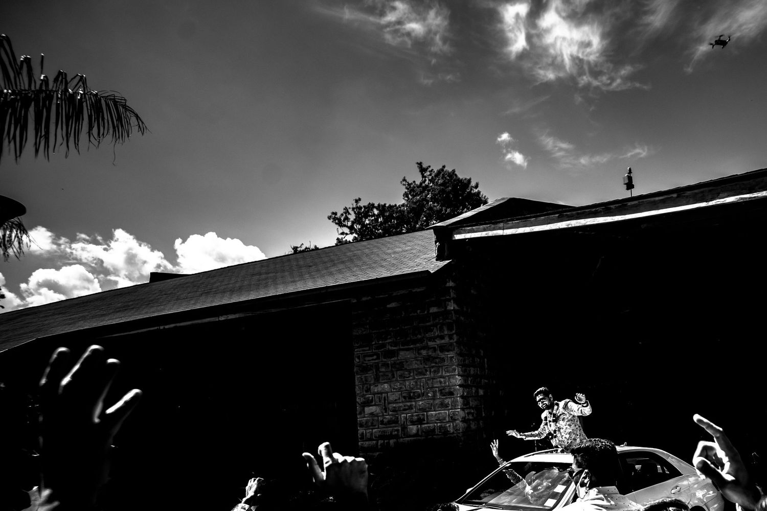 Dramatic black and white skyline silhouette with clouds and architectural elements.