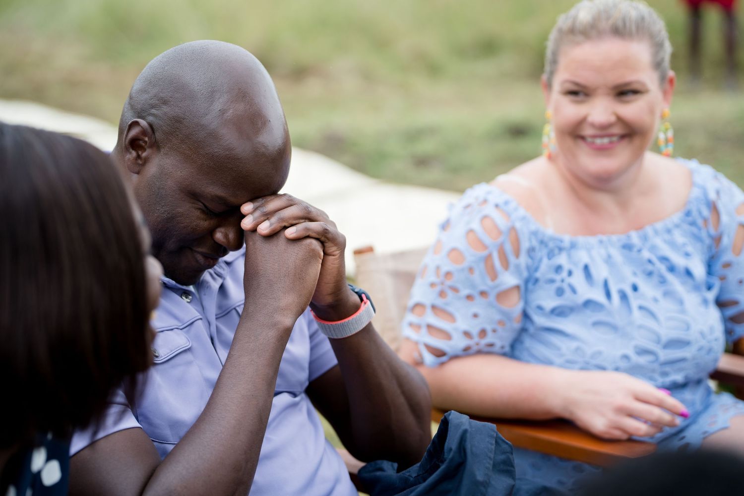 Emotional moment shared between guests during outdoor celebration.