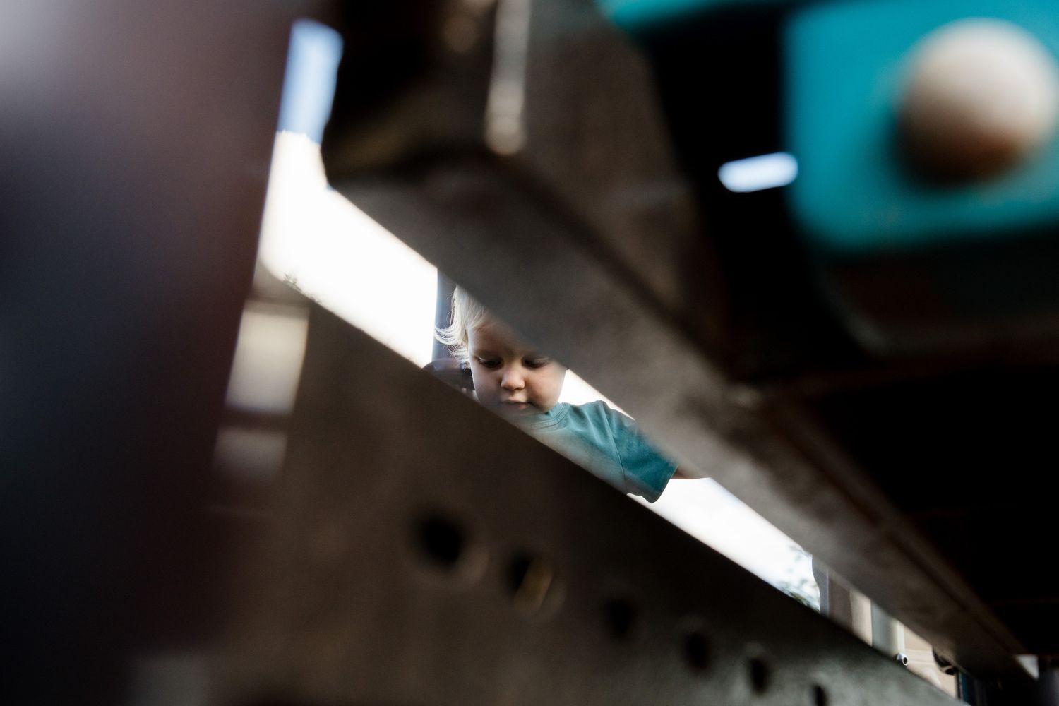 A close-up view of metal machinery parts with blurred industrial equipment in the background.