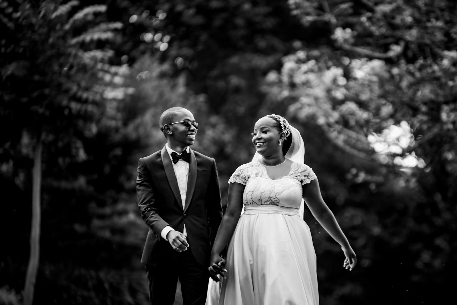 Elegant outdoor wedding ceremony under natural tree canopy.