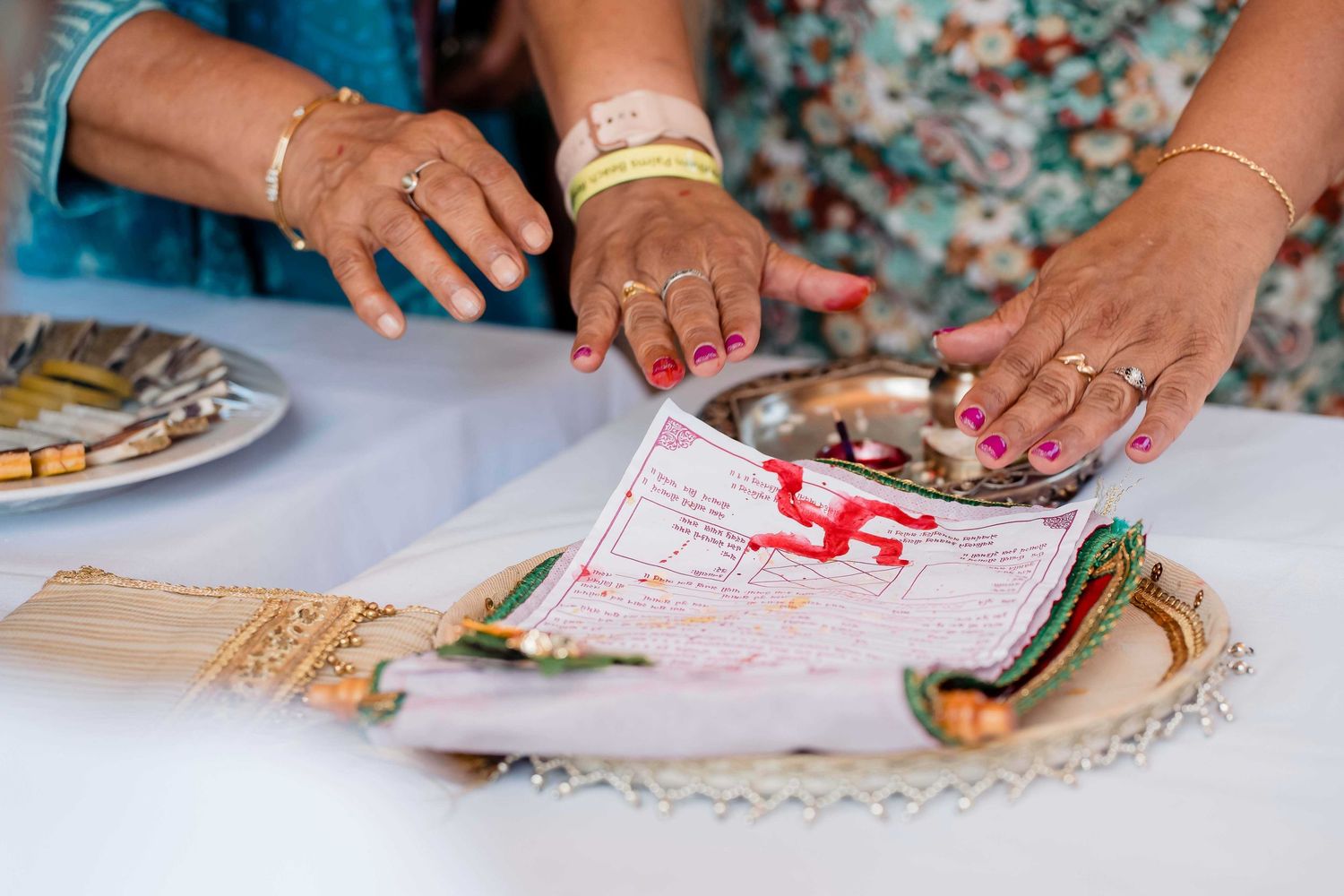 Close-up view of hands rolling and preparing homemade flour tortillas on a floured surface.