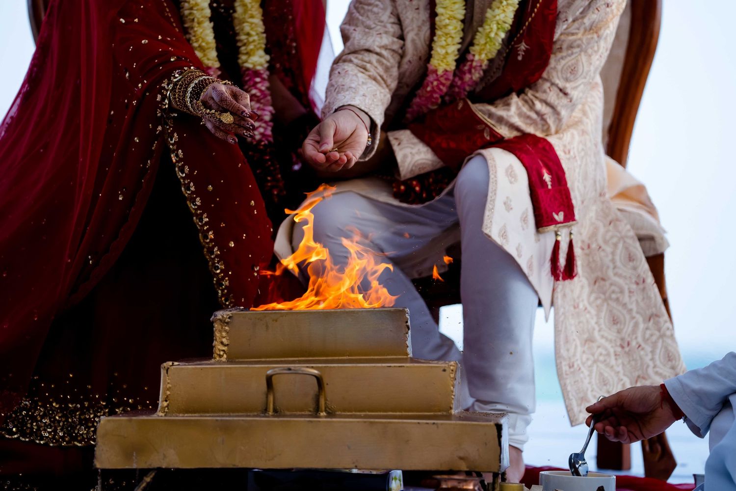 A traditional Indian wedding ceremony with sacred fire ritual and ceremonial decorations in red and gold colors.