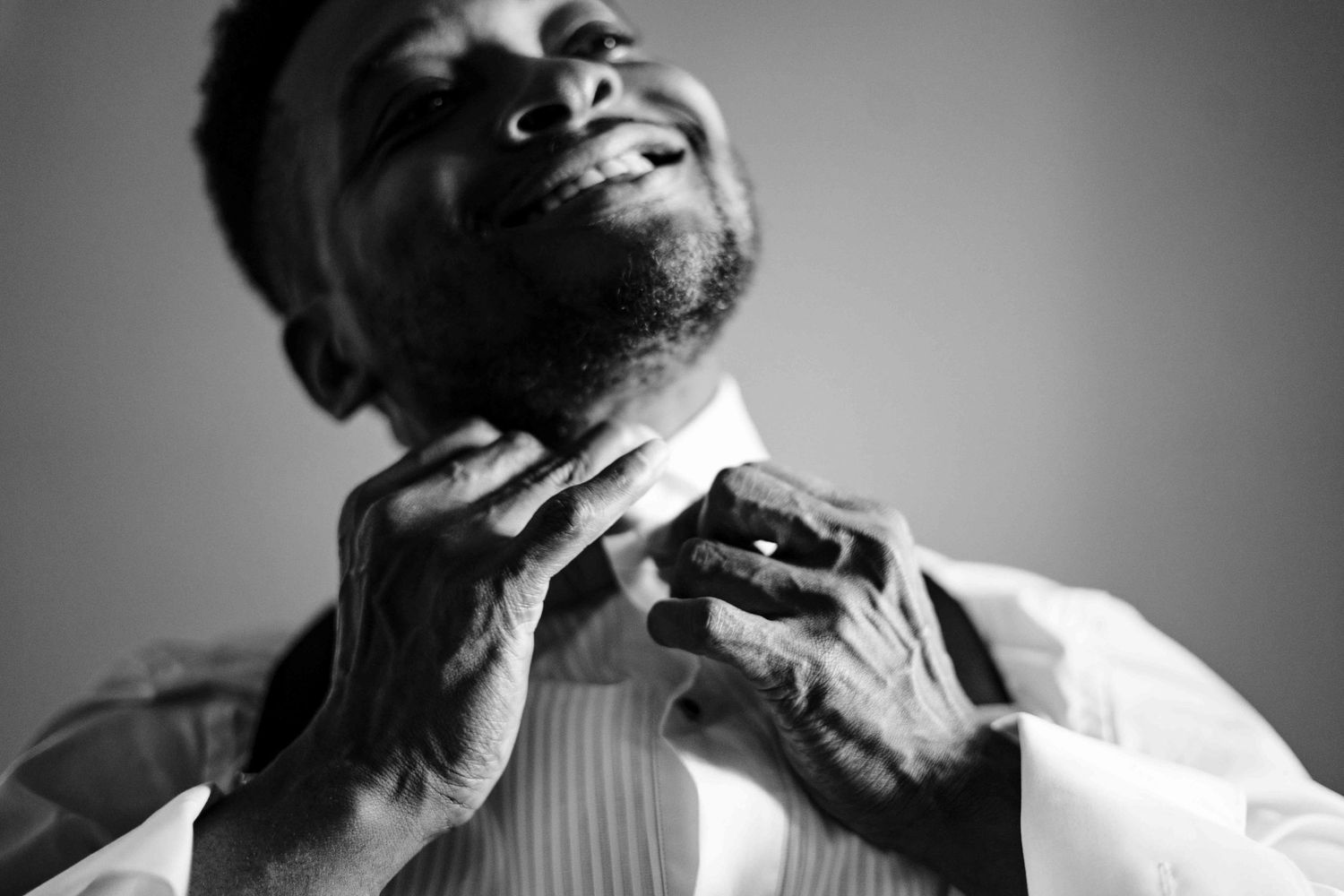 A black and white collage of expressive headshots showing various emotions and angles of laughter and contemplation.