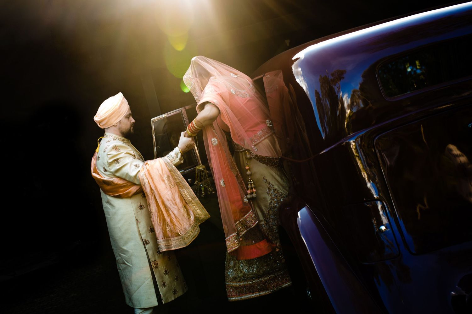 Couple dancing together in an elegant setting with dramatic lighting and flowing dress movement.