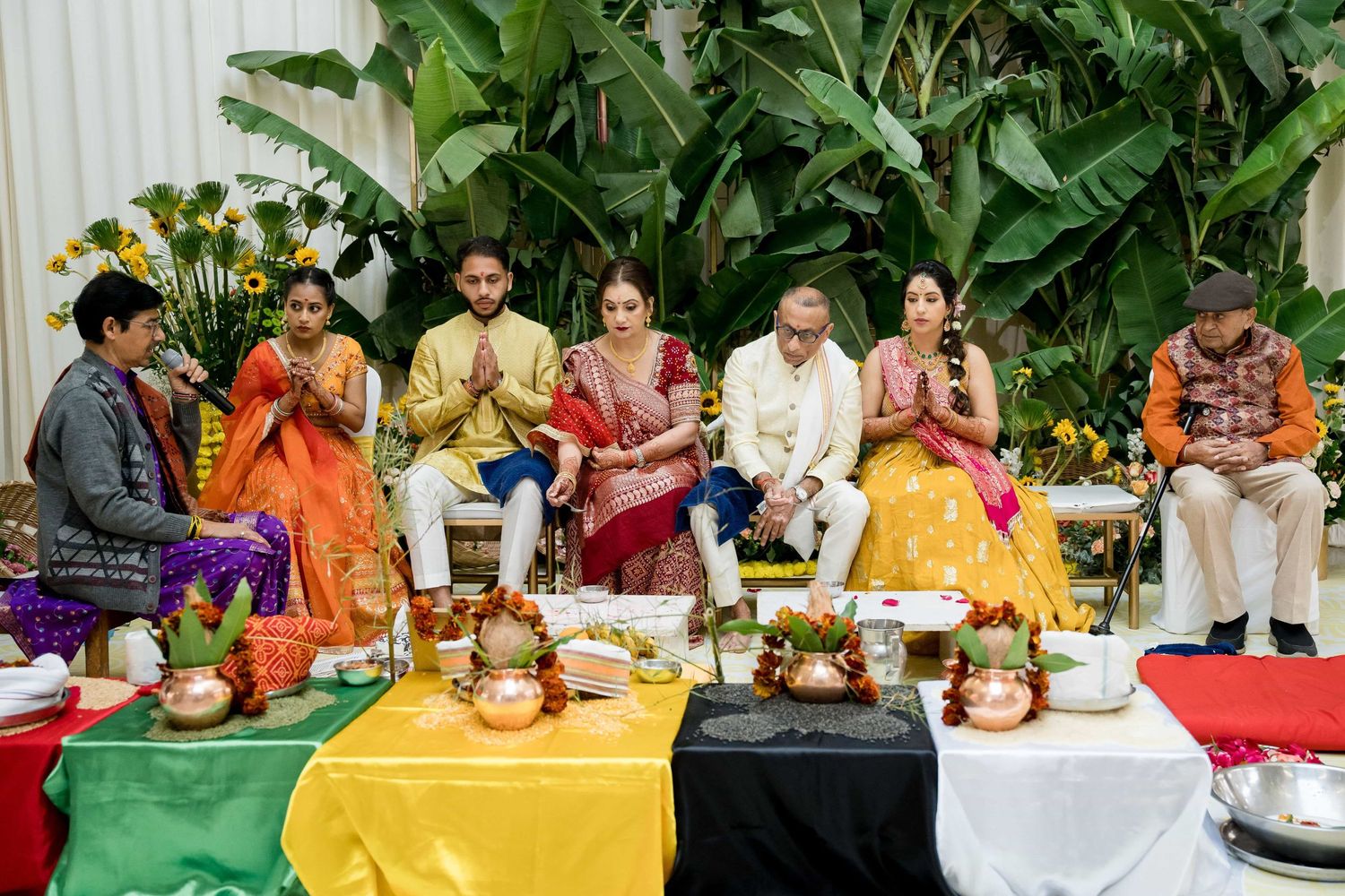 Ceremonial gathering with traditional Indian decorations and colorful table settings.