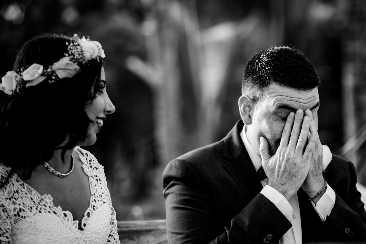 Black and white emotional wedding moment captured during ceremony.