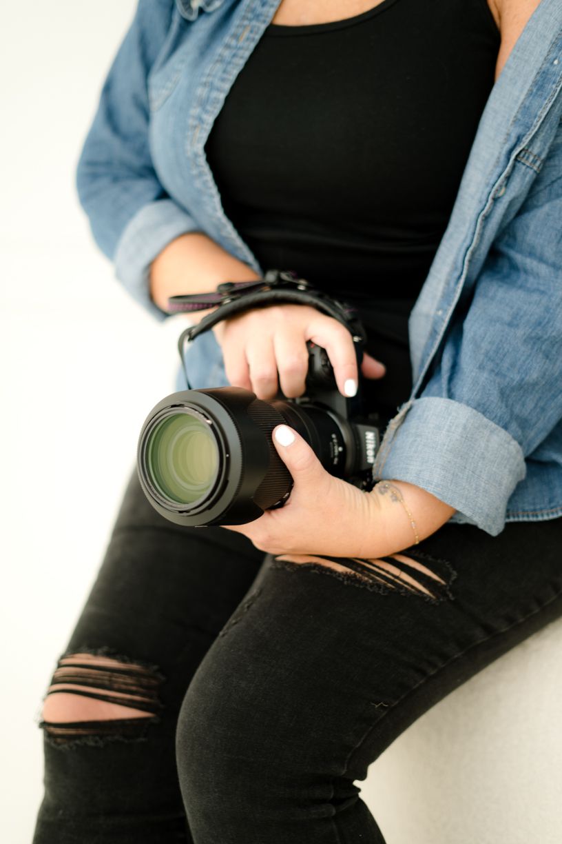 Close-up shots of camera equipment being held against black clothing.
