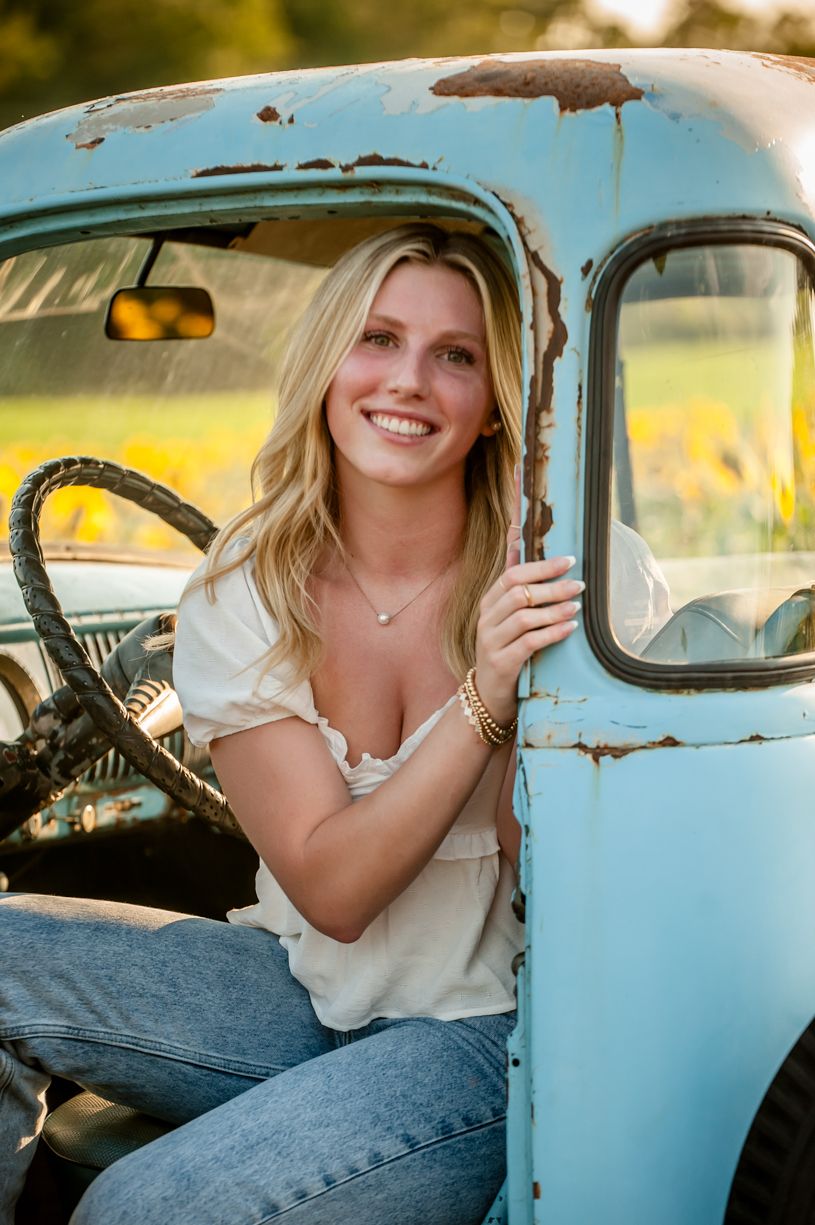 Senior girl Vintage-inspired portraits with classic light blue car during golden hour.