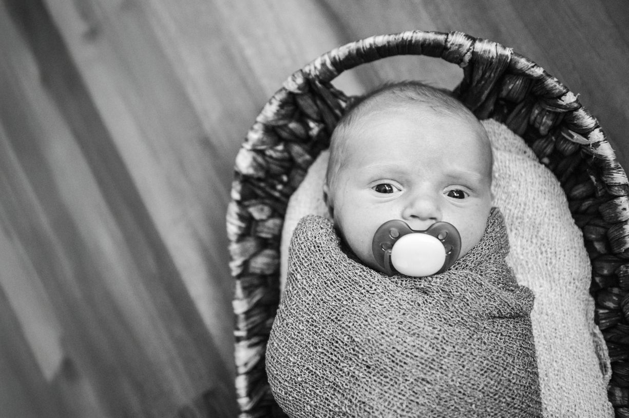 Black and white newborn photography with dramatic lighting and texture in Mooresville, NC