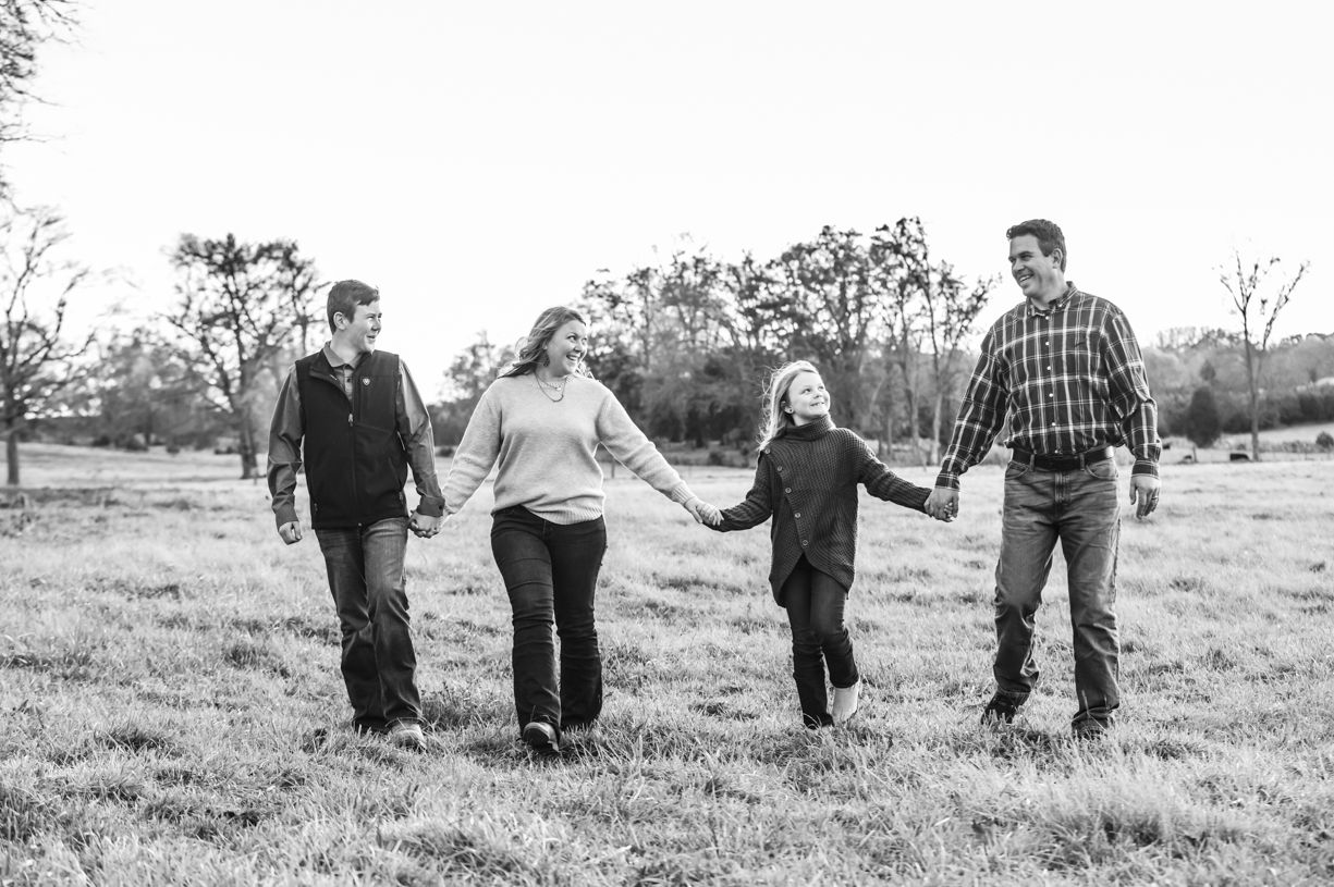 Family of four laughing during portrait session in Lake Norman NC